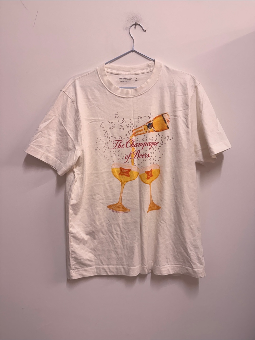 Abercrombie & Fitch Cream Graphic Tee with Gold Champagne Print